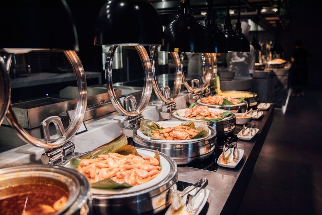 A tempting display of a luxurious buffet with various prepared dishes under warm lighting.