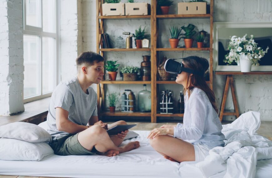 Young couple engaged with virtual reality and technology indoors.