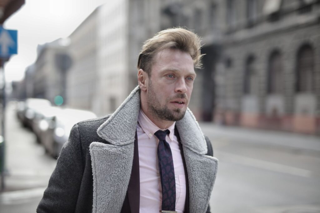 Portrait of a fashionable man in urban street setting on an overcast day.