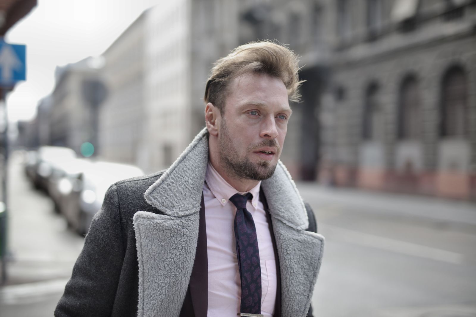 Portrait of a fashionable man in urban street setting on an overcast day.