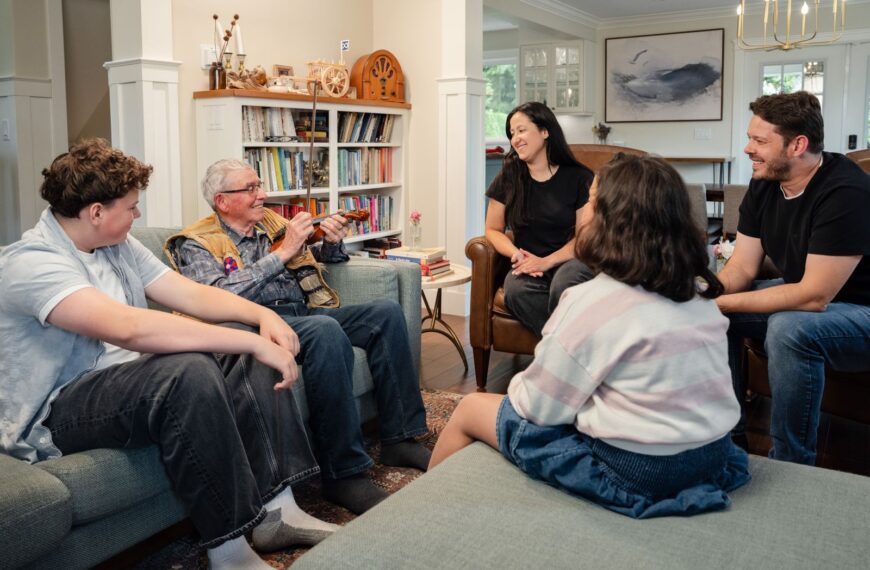 A diverse family shares laughter and stories while spending quality time together in a cozy living room.