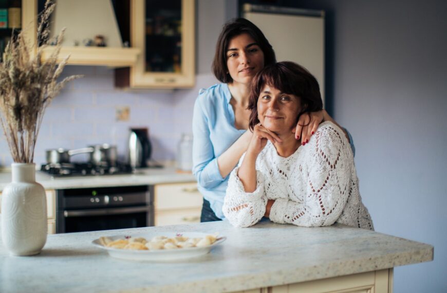 A loving moment shared between mother and daughter in a cozy kitchen, depicting warmth and bonding.
