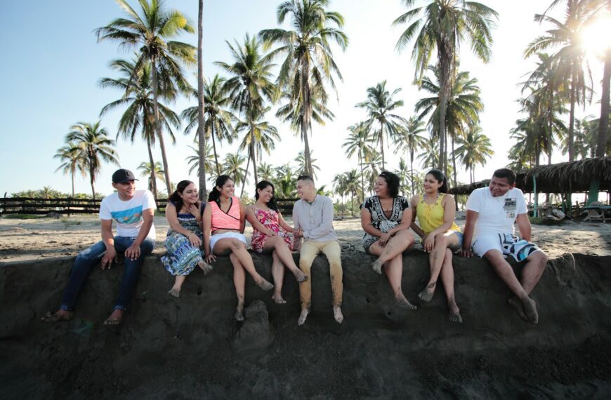 group of people sitting on san