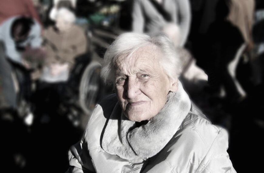 Portrait of an elderly woman in a winter coat. Outdoor setting with a blurred background.