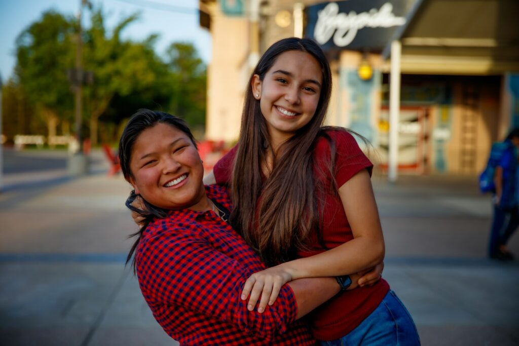 a woman hugging another woman