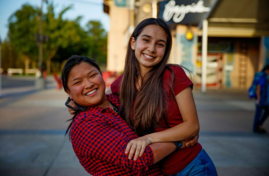 a woman hugging another woman