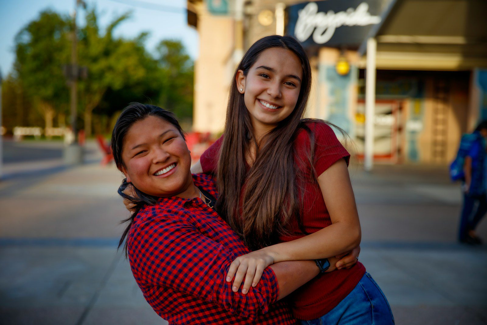 a woman hugging another woman