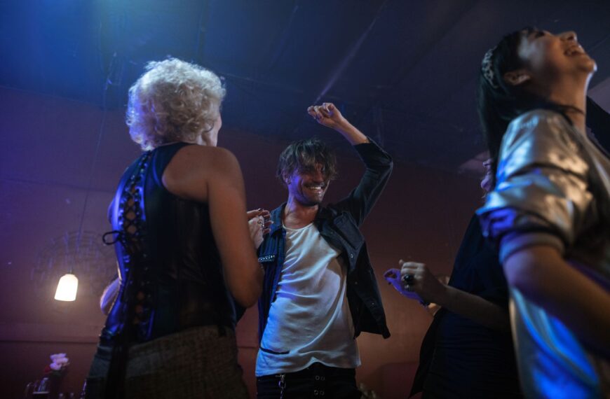 Lively indoor party with adults dancing under club lights, capturing nightlife excitement.