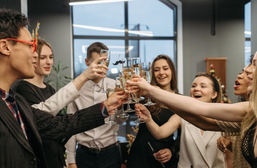 A joyful group toasting with champagne at a festive indoor celebration.