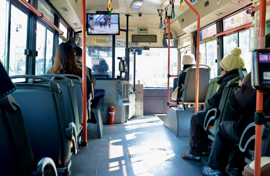 a group of people sitting on a bus next to each other