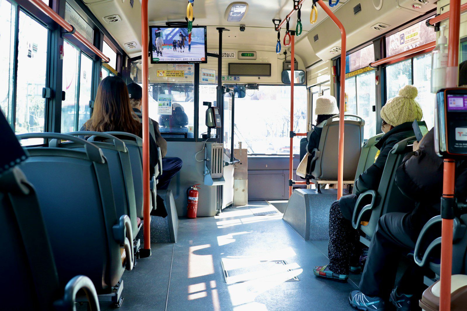 a group of people sitting on a bus next to each other