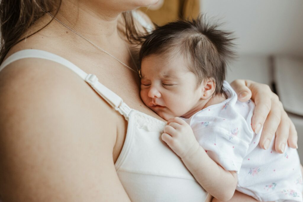 a woman holding a baby in her arms