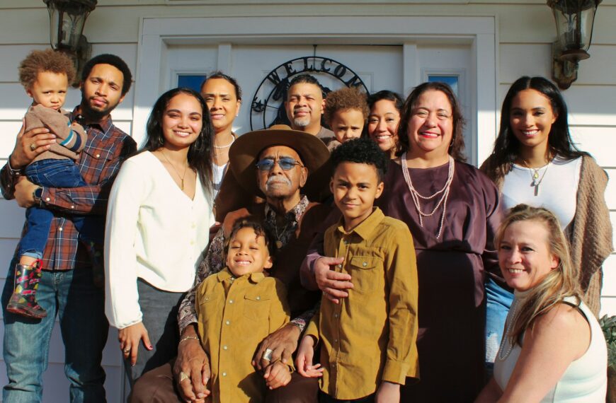 group of people standing near white wall