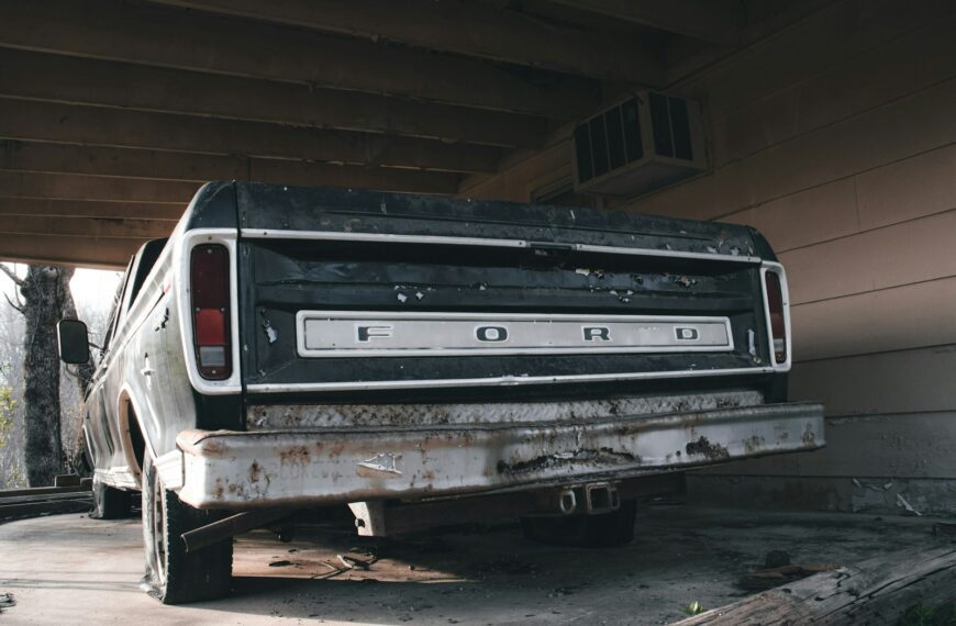 an old ford truck parked in a garage