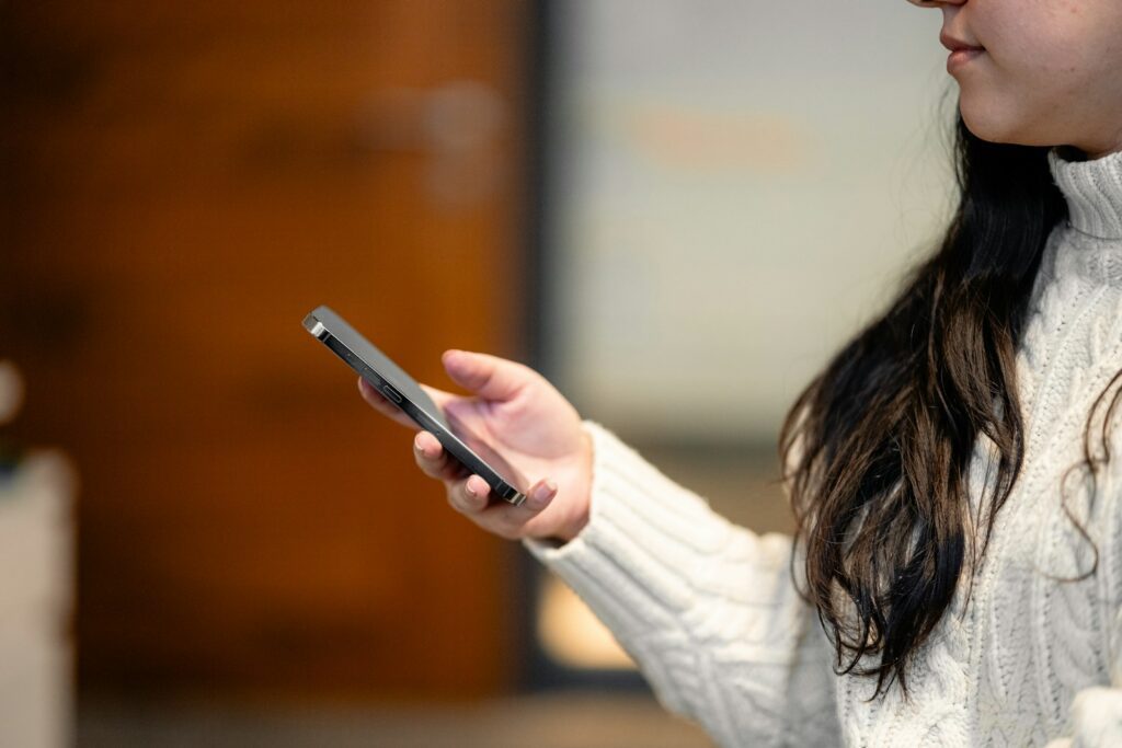 a woman holding a cell phone in her hand