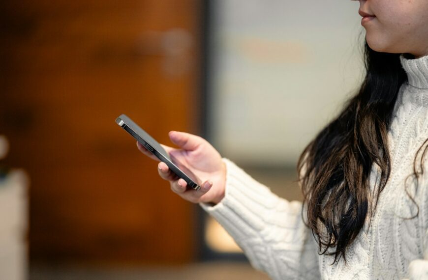 a woman holding a cell phone in her hand
