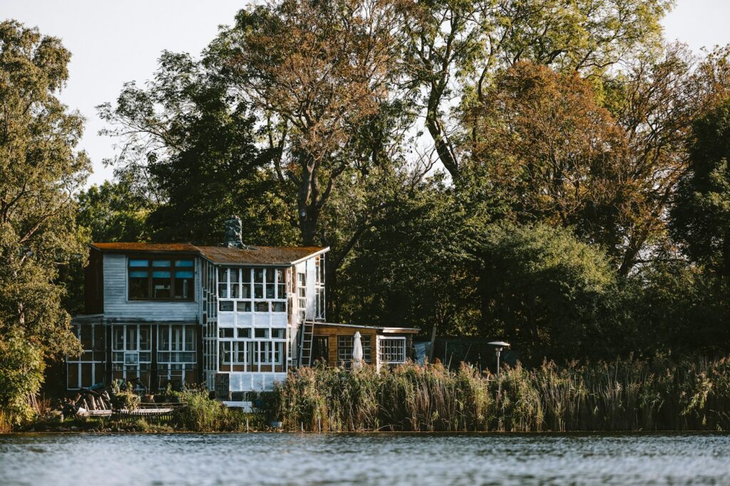 Modern house by the water surrounded by trees