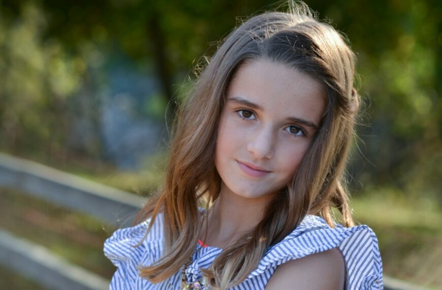 a young girl is posing for a picture