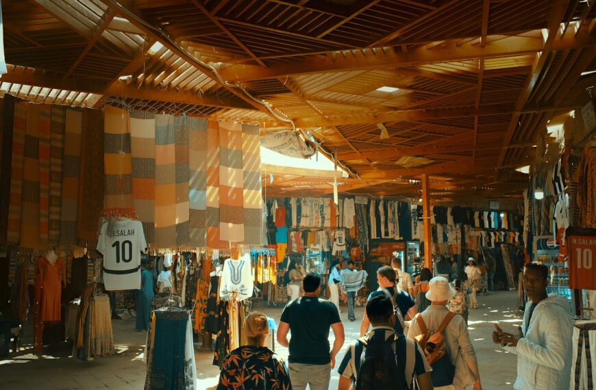 People browse colorful stalls in a bustling market.