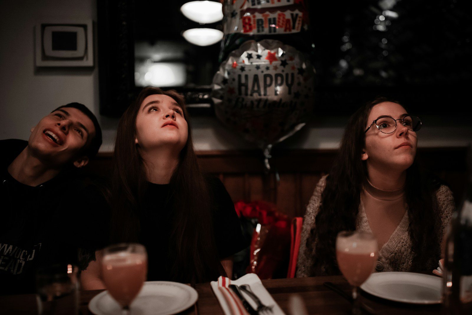 a group of people sitting at a table with drinks