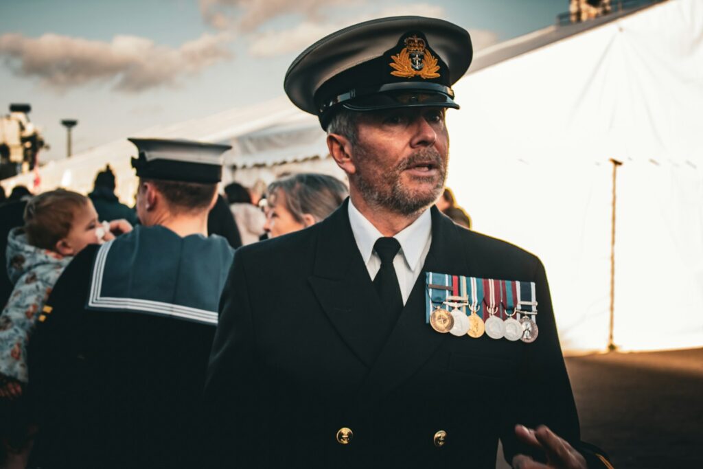 a man in a military uniform standing in front of a crowd