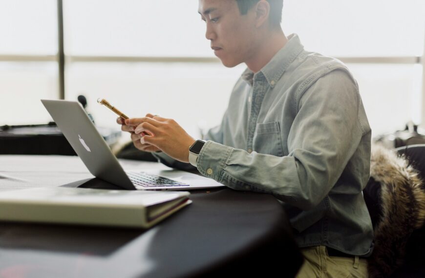 a man sitting in front of a laptop computer