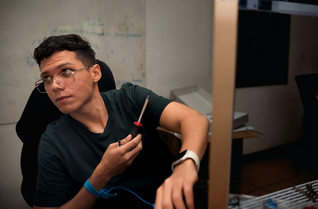 A man sitting in front of a computer monitor