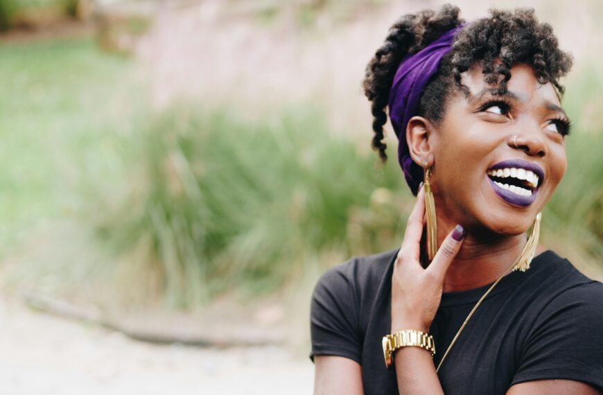 photo of woman wearing purple lipstick and black crew-neck shirt