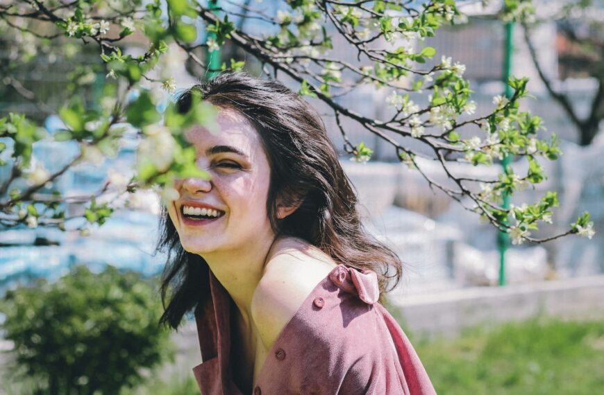 woman in pink coat smiling