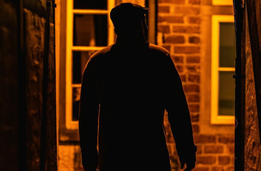 A man walking down a dark alley way