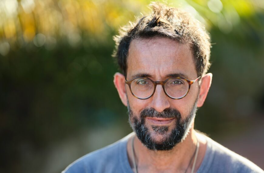 man in blue crew neck shirt wearing black framed eyeglasses