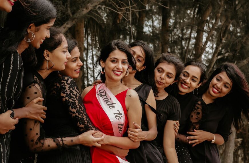 Smiling women enjoying a lively bachelorette party outdoors, showcasing friendship and happiness.