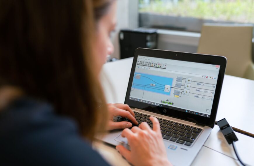A woman engineer focuses on software analysis using a laptop indoors.