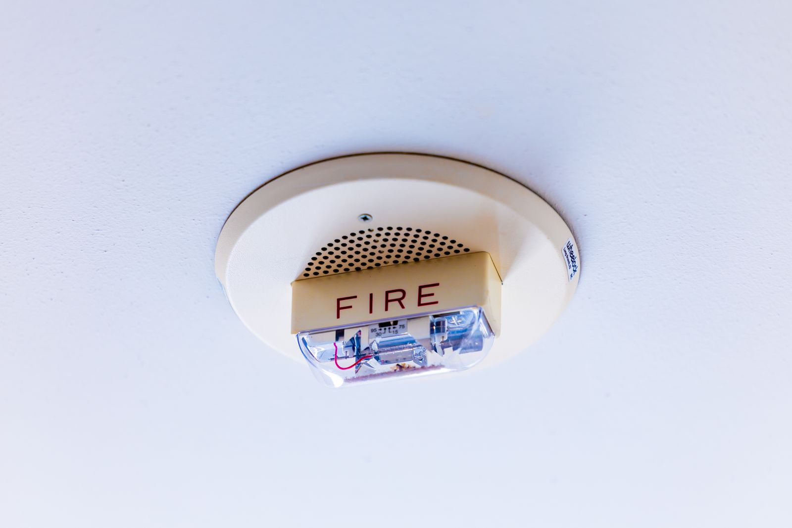 Close-up view of a ceiling-mounted fire alarm system ensuring safety in a building.