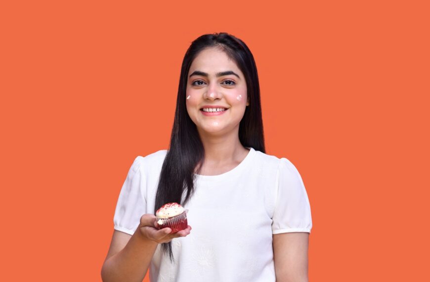 a person holding a cupcake