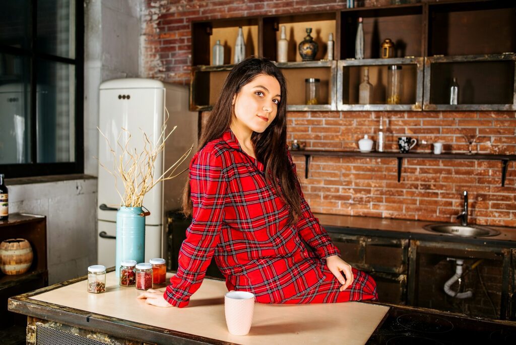 woman in red and black plaid dress shirt sitting on chair