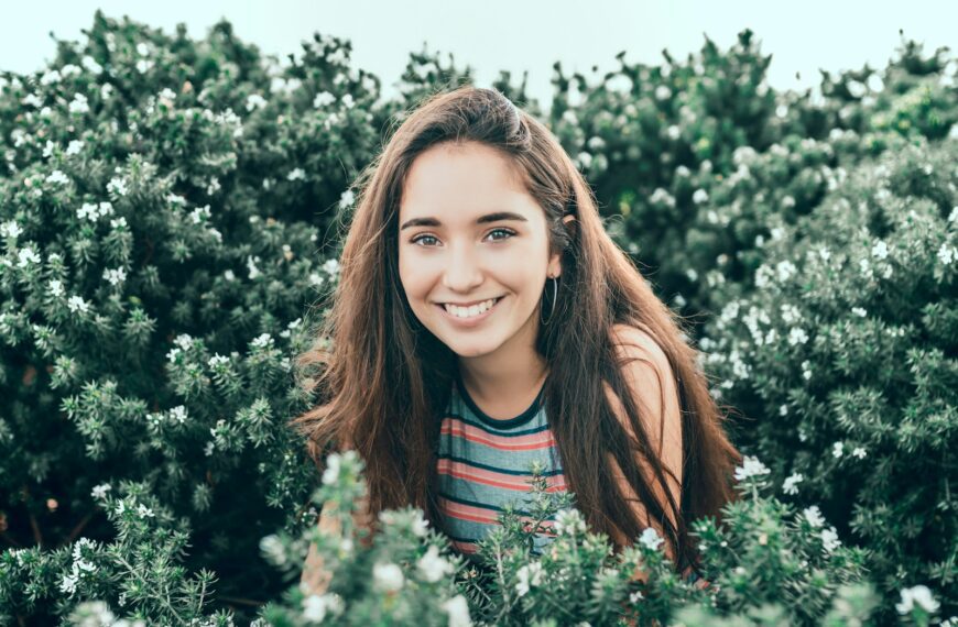 woman standing in bushes