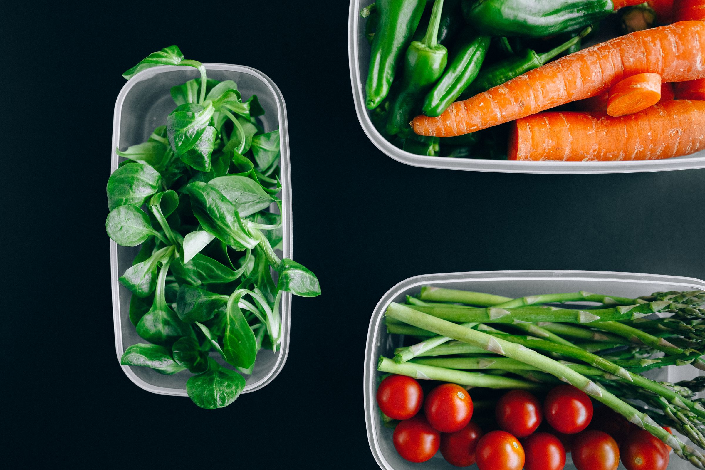 Fresh vegetables portioned into containers for meal prep and food storage