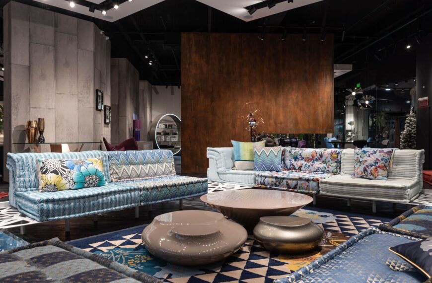 Modern furniture showroom displaying sofas and coffee tables on a patterned rug