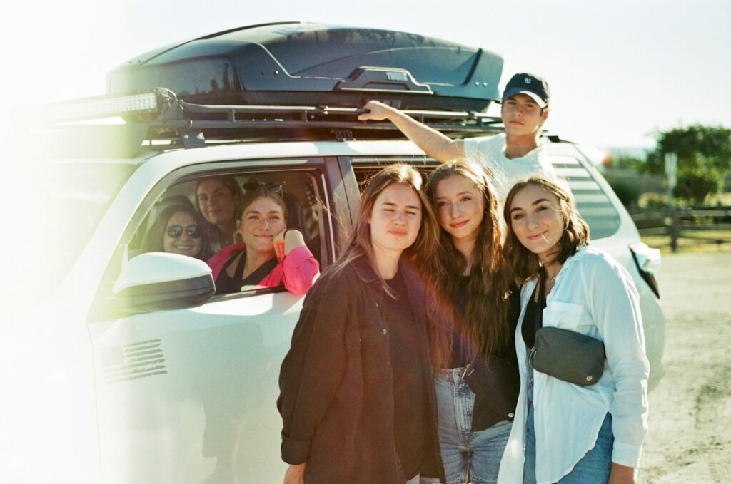 a group of people standing in front of a van