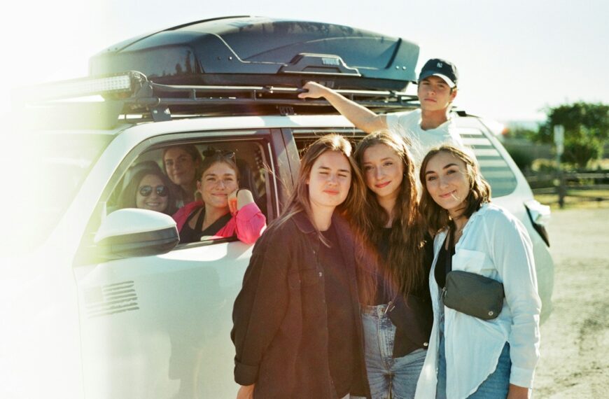 a group of people standing in front of a van