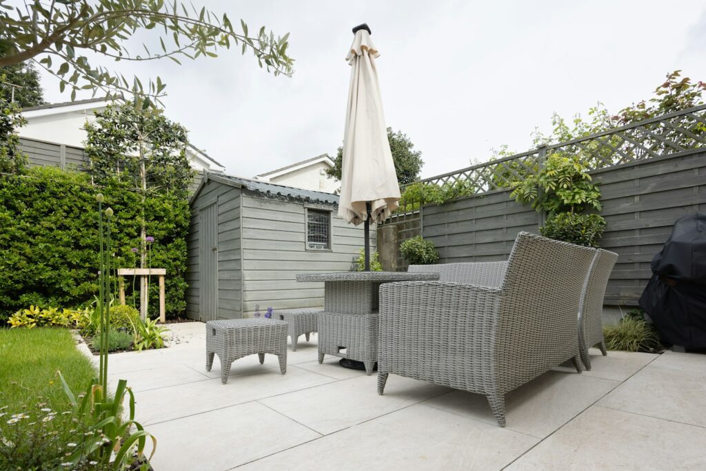 A patio with a table and chairs and an umbrella