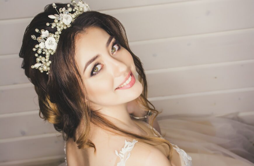 woman with white floral headdress beside white wall