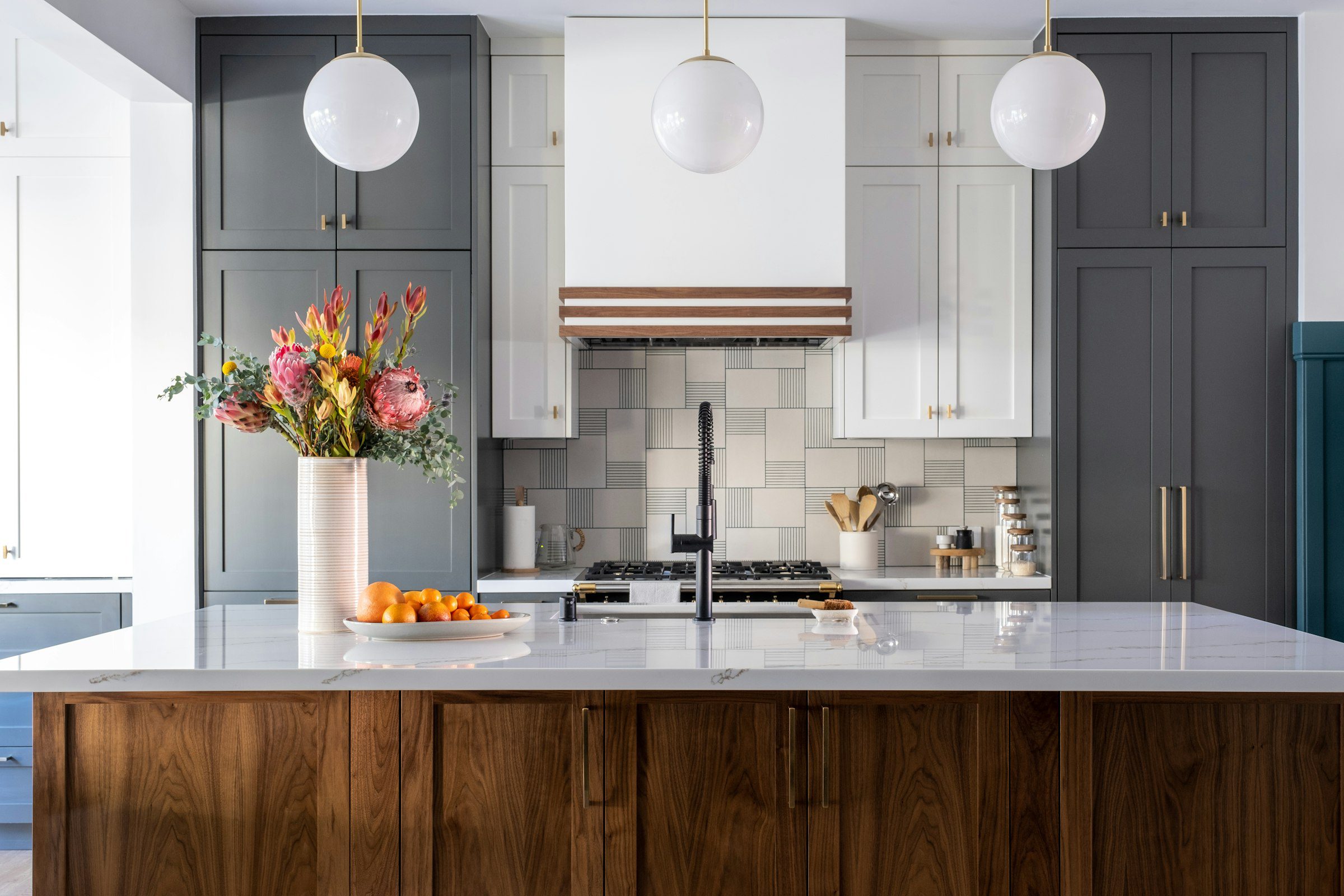Bright renovated kitchen with white marble countertop and modern fixtures