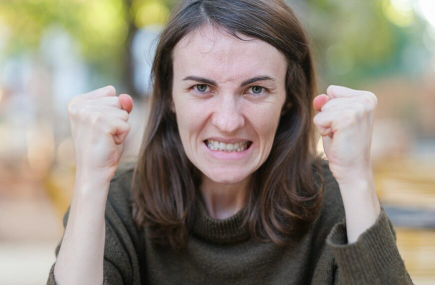 a woman holding her fists up in the air