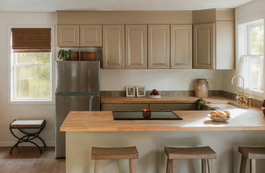 Modern kitchen featuring light natural wood countertops and a matching wood island, reflecting the 2026 shift toward warm wood tones
