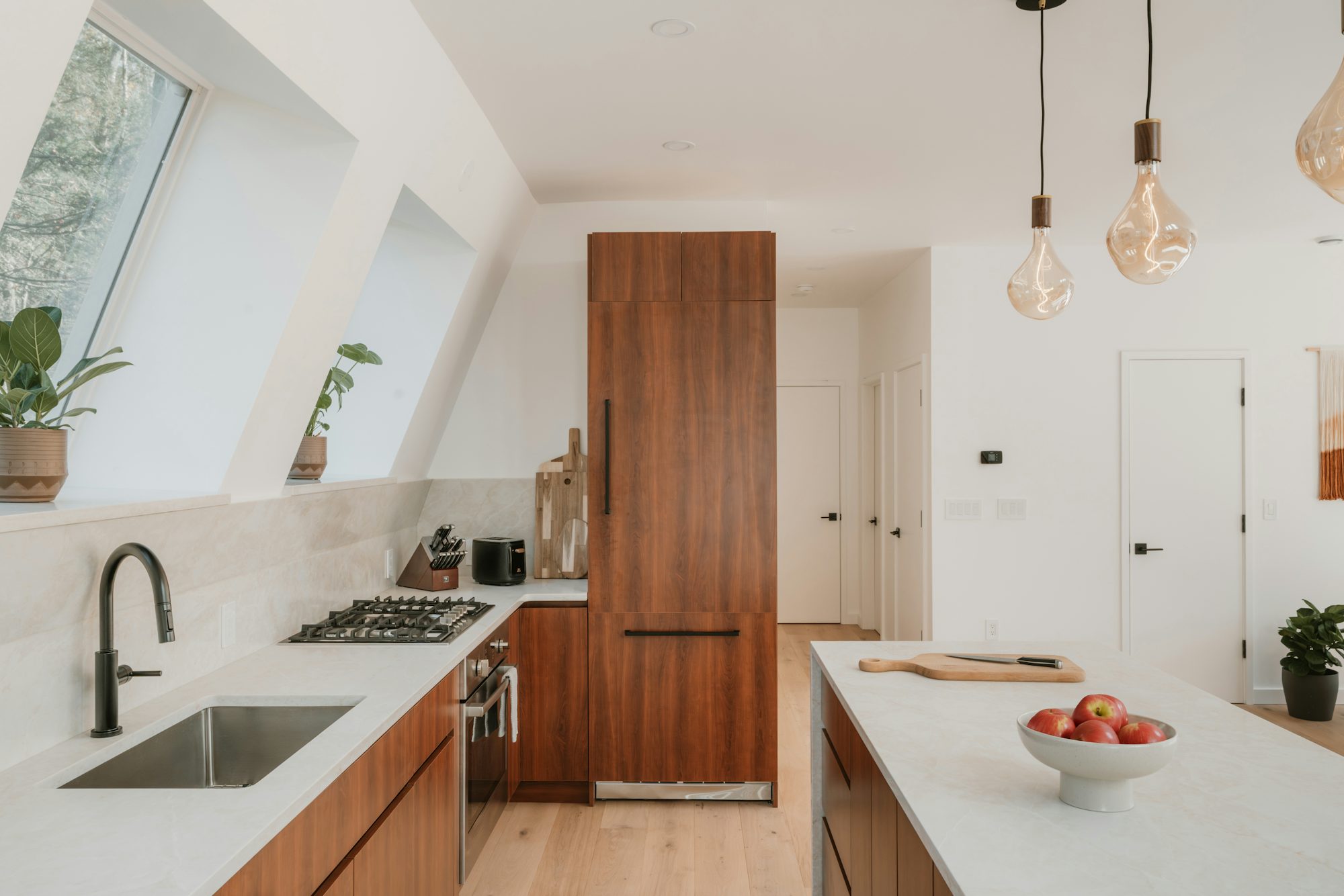 Kitchen renovation with natural wood cabinetry and island, illustrating the 2026 trend away from painted white cabinets