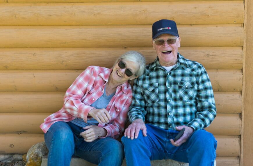 Elderly couple sitting together outdoors