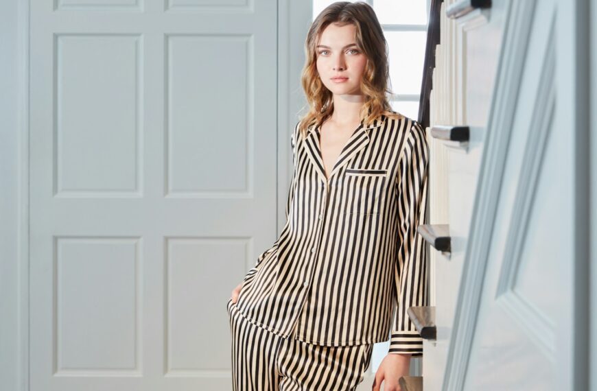 Young woman wearing striped pajamas indoors
