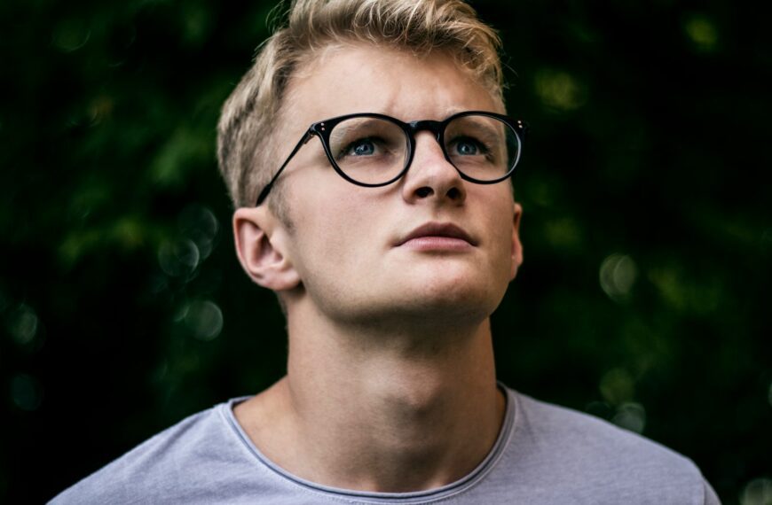 selective focus photography of man wearing eyeglasses